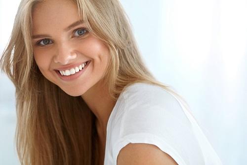 Woman smiling after teeth whitening in Lakeland FL