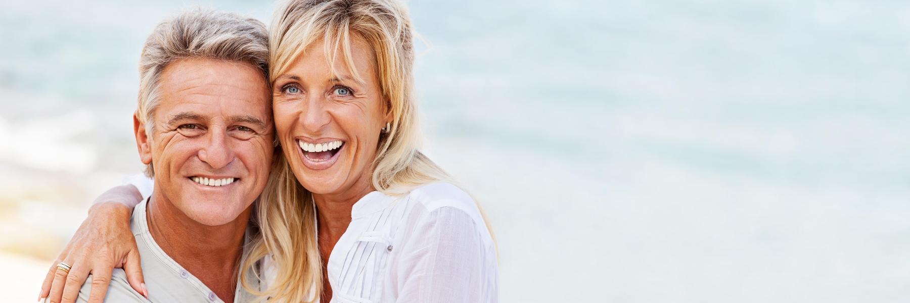 Married couple smiling on the beach near Lakeland FL