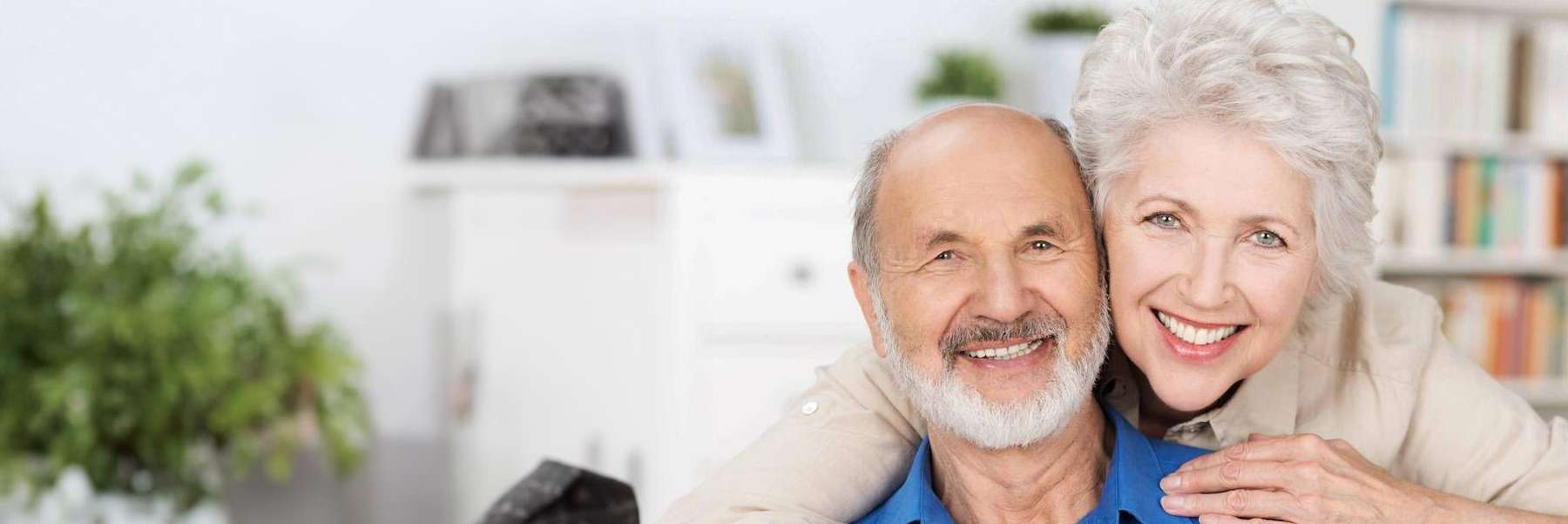 Couple in Lakeland FL confidently smiling with their full dentures