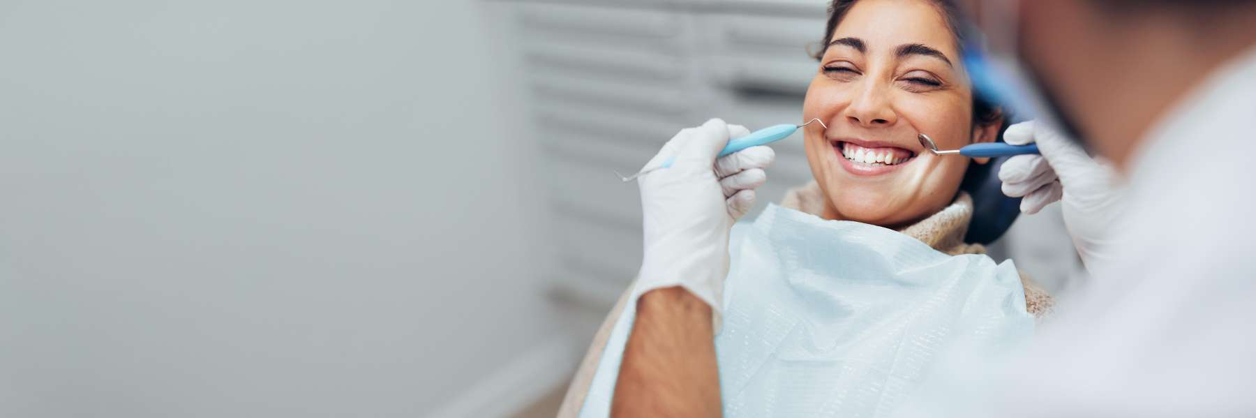 Woman in treatment chair at dentist for dental crowns in Lakeland, FL