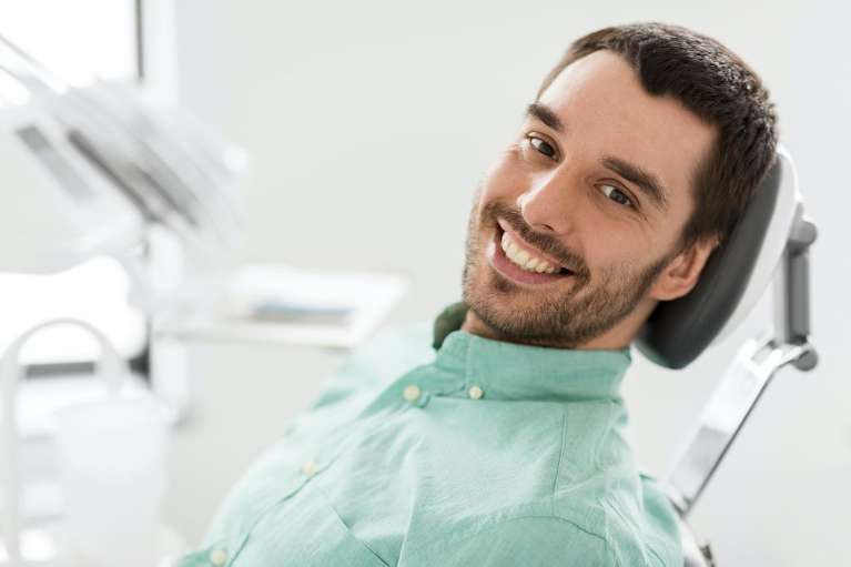Man smiling in dental chair, lakeland fl