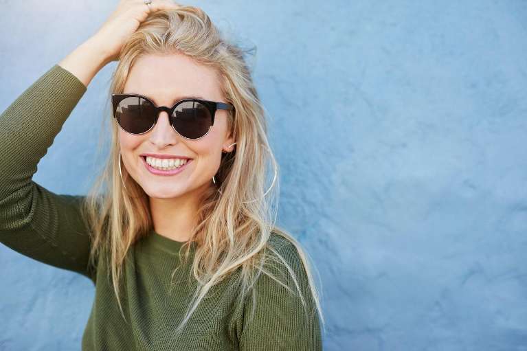 Woman with blonde hair and sunglasses smiling, lakeland fl