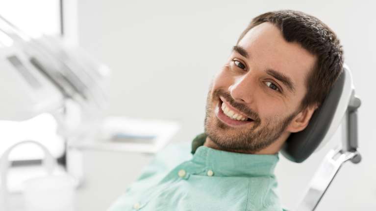 Patient smiling in treatment chair at dentist in Lakeland, FL