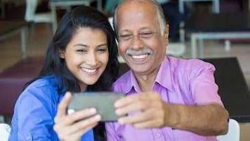 Happy father and daughter capture a joyful moment together as they smile while taking a selfie