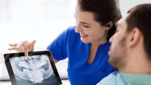 A dental x-ray of the man is displayed by a female dentist in Florida