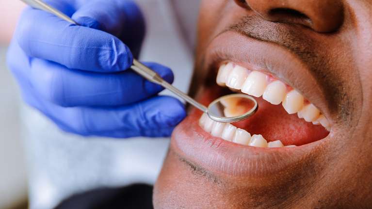 A man sitting comfortably on a dental chair