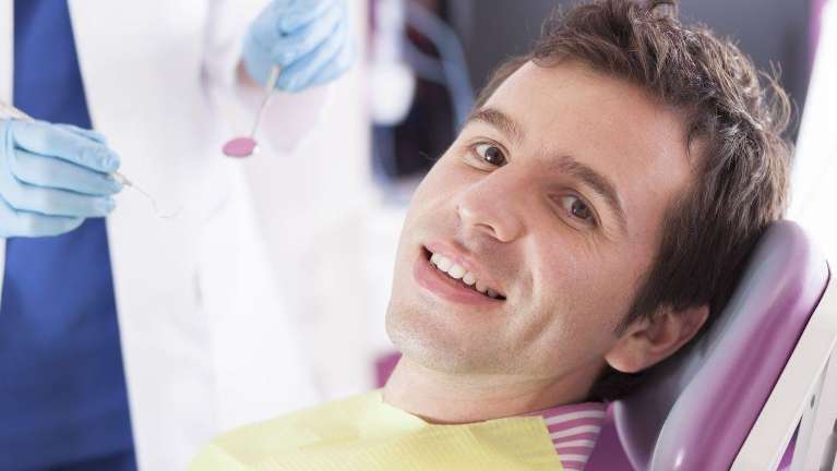 A man in a dental chair receiving a dental examination in Florida
