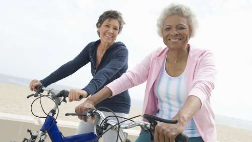 Older black and white woman smiling on bikes, lakeland fl